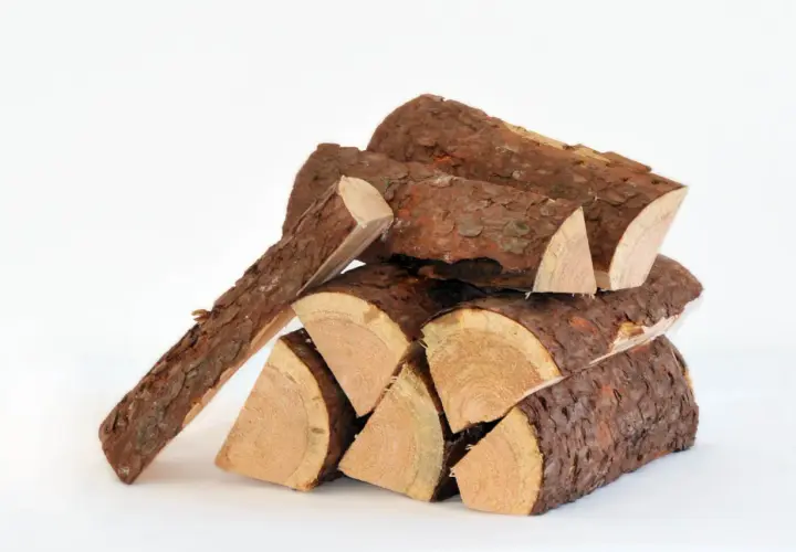 Stapel gespaltenes Fichtenholz, bereit zum Fichtenholz verbrennen. Die Rinde ist rau, das Holz innen hell.