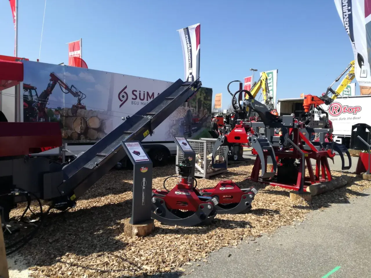 Holzspaltmaschinen und Kräne von SÜMA BGU Maschinen auf einer Messe.