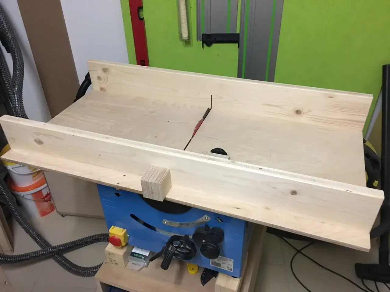 Große tischkreissäge mit Holzplatte und Sägeblatt bereit für den Zuschnitt.