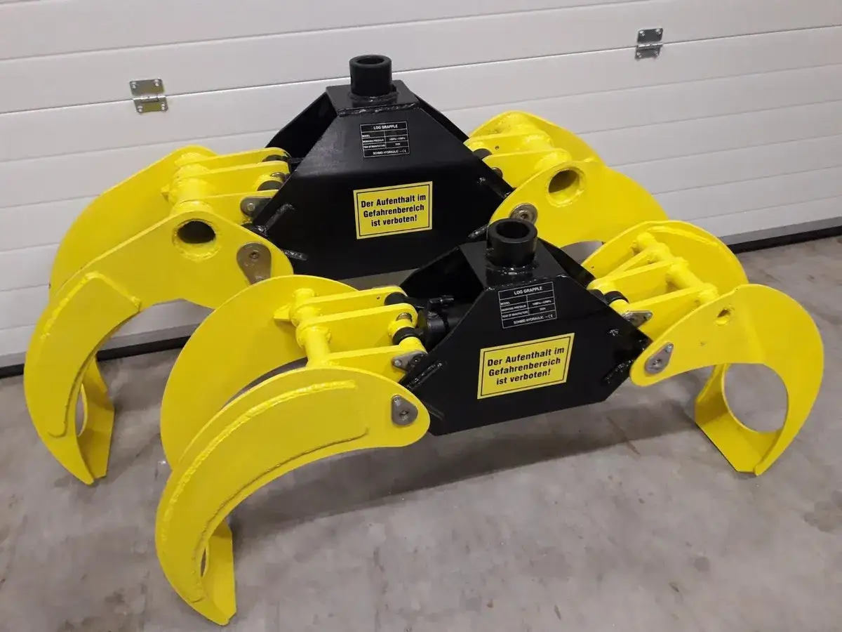 Zwei gelbe, hydraulische Forstzangen mit schwarzen Aufnahmen, bereit für den Holzeinsatz.